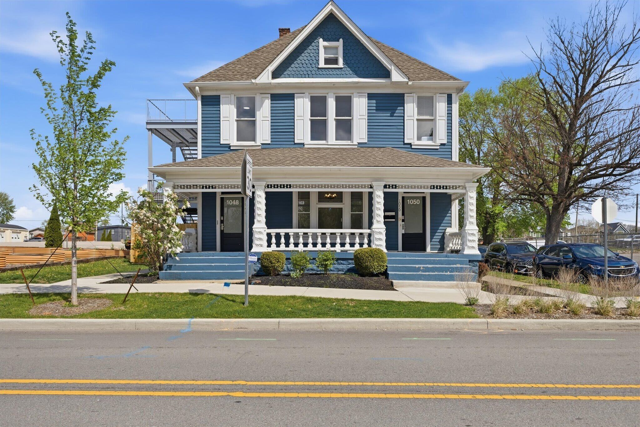A two-story house with a porch, a small balcony, and a garage.