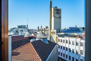 Eine Stadtsicht mit einem markanten Gebäude mit der Aufschrift 'COLIRCU DO PORTO' und verschiedenen Dächern.