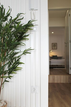 A room with a bed, a bedside table, a lamp, and a wall-mounted telephone. - Valbom Hideaway Light, Style and Peace (Valbom)