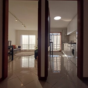 A modern apartment with a living room, kitchen, and laundry area. - Perfect Oporto with Terrace and Good Vibes (Oporto)