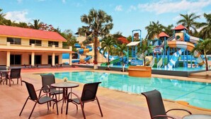 A hotel with a swimming pool, outdoor seating, and a water park. - Treat Imperial Jim Corbett (Ramnagar)