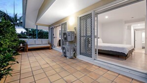 A modern room with a bed, a sofa, and an air conditioning unit. - Coastal Luxe - Diamond Beach 168 (Mermaid Beach)