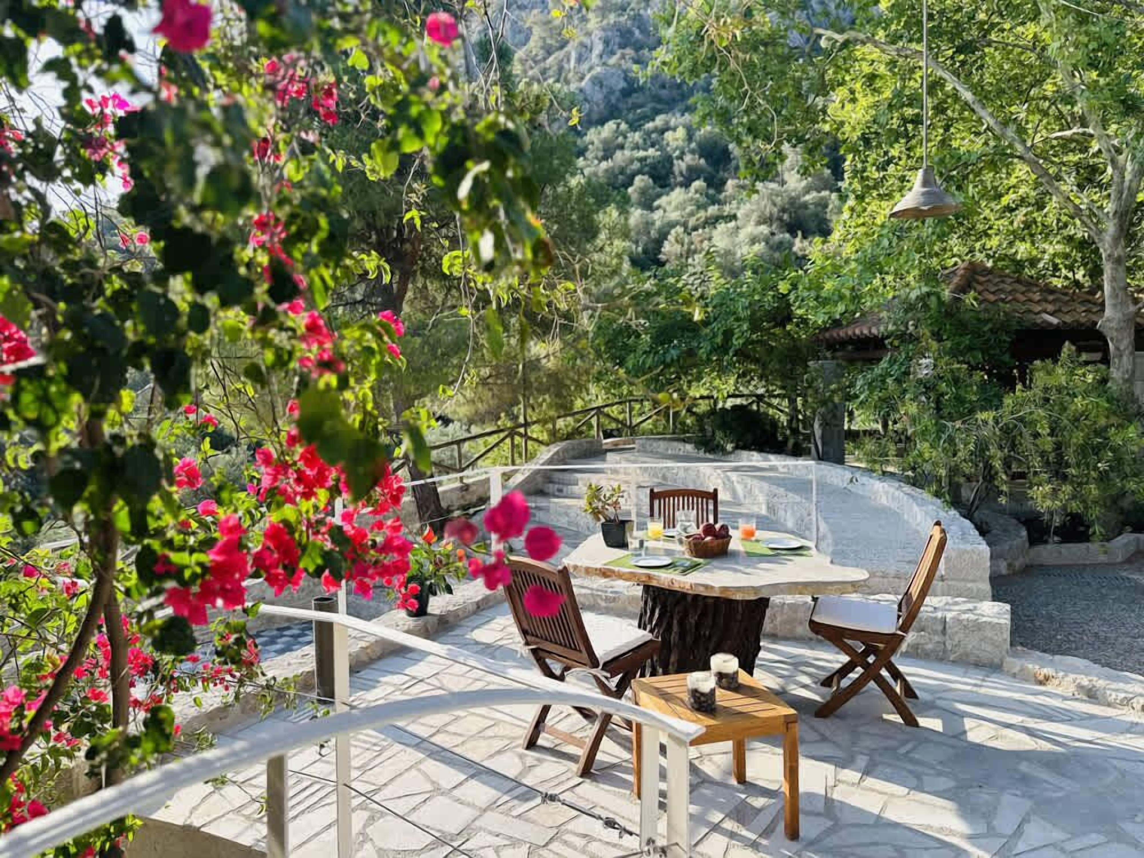 Outdoor Dining Area Surrounded by Flowers and Greenery