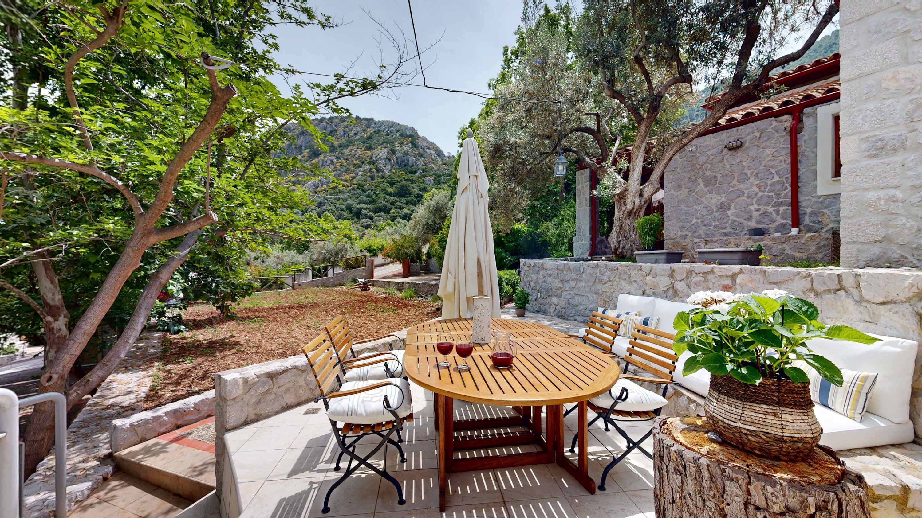 Private Garden Terrace with Outdoor Dining and Stone Walls