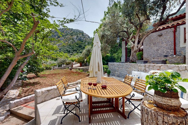 Private Garden Terrace with Outdoor Dining and Stone Walls