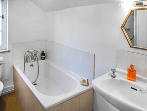 A bathroom with a bathtub, a sink, and a toilet.