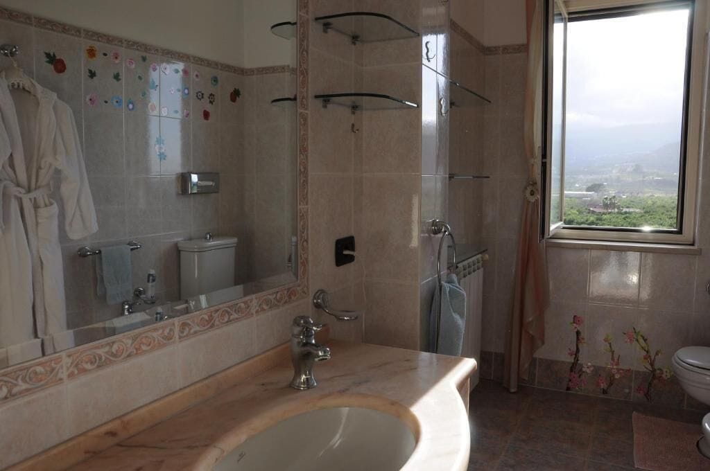 Bathtub, hair dryer, towels, toilet paper
