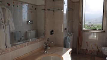 Bathtub, hair dryer, towels, toilet paper