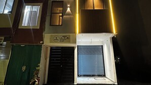 Ein mehrstöckiges Gebäude mit beleuchteten Fenstern und einer geschlossenen Schaufensterfront.