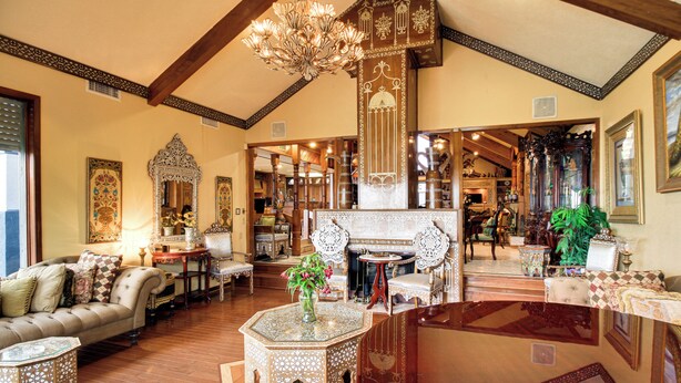A spacious living area with a fireplace, ornate furniture, and a chandelier. - Luxe Waterfront Living: Portland Home w/ Pier! (Portland)