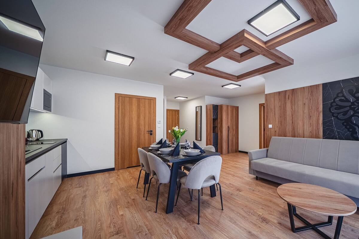 A modern living space with a dining area, a sofa, and a coffee table.