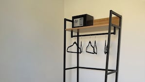 A bunk bed with a storage shelf, a small table, and a chair. - Raeti Fira Residence (Santorini)