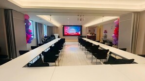 A conference room with a long table, chairs, a projector screen, and balloons. - Ji Hotel Wuhan Hankou Xinhua Road (Wuhan)