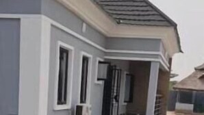 A residential building with a tiled entrance and a staircase leading to the door. - Charming Executive Suite with Garden Views at AJALA Lodge, Badagry (Badagry)