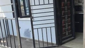 A gated entrance to a building with a tiled floor and a small garden area. - Charming Executive Suite with Garden Views at AJALA Lodge, Badagry (Badagry)