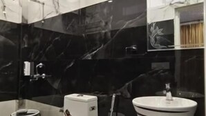 A modern bathroom with a toilet, bidet, and a large striped sink. - Joey's hostel Jaipur (Jaipur)