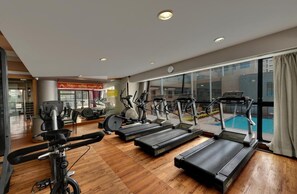 A gym with treadmills, stationary bikes, and elliptical machines. - The Fern Residency (Mumbai)