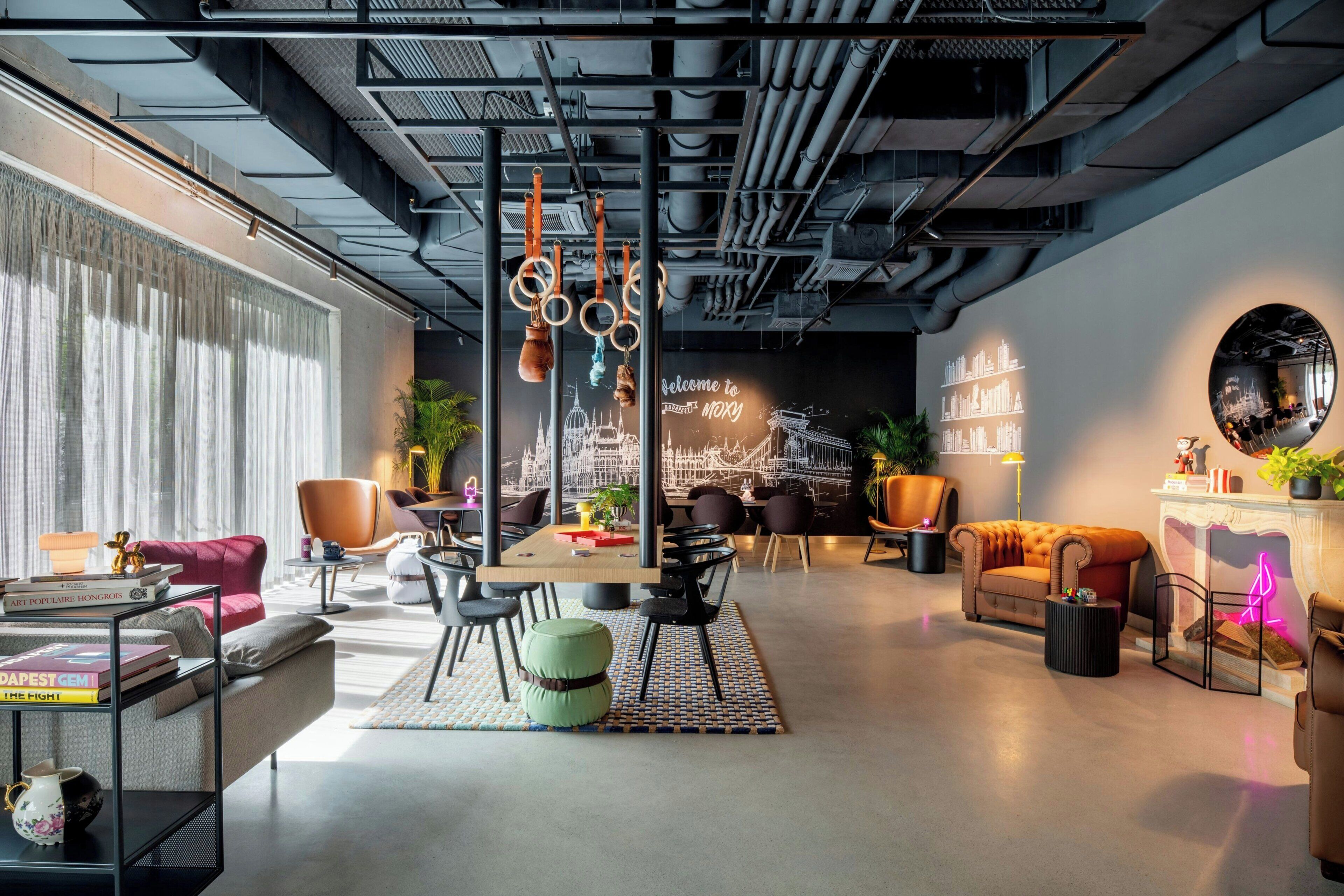 A modern interior with a dining area, sofas, and a fireplace.
