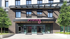 A modern building with a neon sign reading 'noxy' and a glass entrance. - Moxy Budapest Downtown (Budapest)