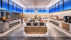 A modern hotel lobby with a central island, seating area, and a reception desk. - Novotel Chengdu Chunxi Road (Chengdu)