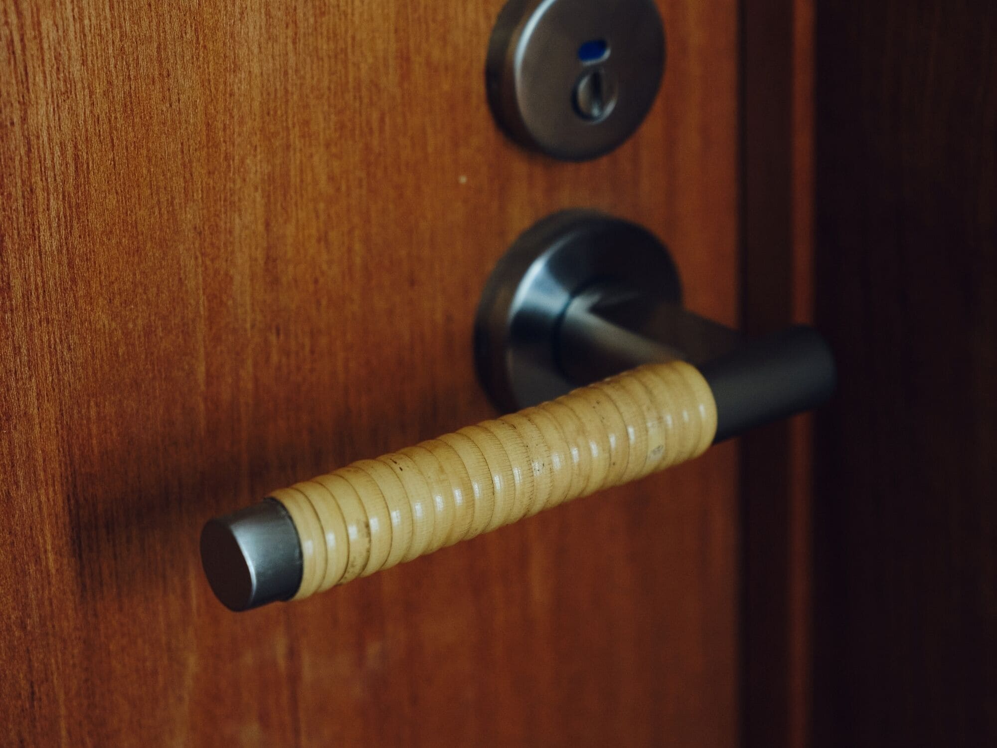 A wooden door with a keyhole and a door handle.