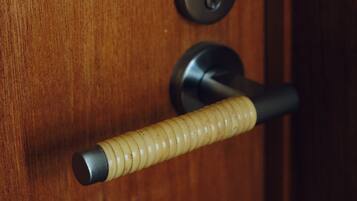 A wooden door with a keyhole and a door handle.