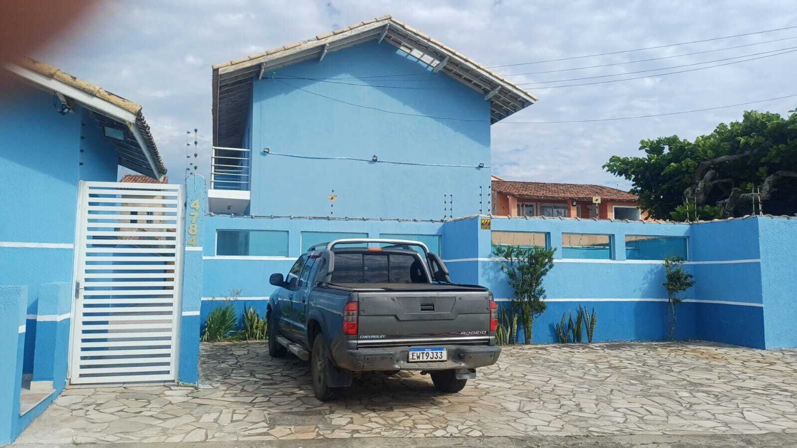 A blue building with a truck parked in front.