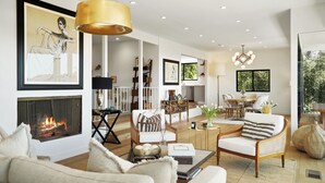 A modern living room with a fireplace, comfortable seating, and a dining area. - Pool + Hot Tub + Skyline Views | Hollywood Hills | Mulholland Vista Estate (Los Angeles)