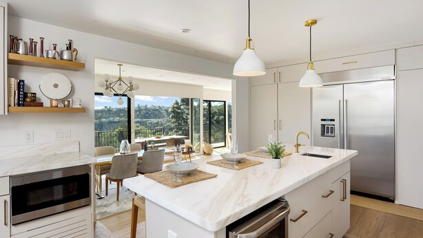 A modern kitchen with a large island, stainless steel appliances, and a view to the outdoors. - Pool + Hot Tub + Skyline Views | Hollywood Hills | Mulholland Vista Estate (Los Angeles)