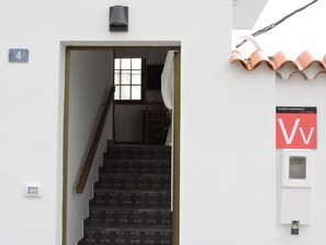 A staircase leading to a room with a window, a door with a number plate, and a sign indicating 'Viviendas Vacacionales'. - Casa Con Piscina Aislada, a 5 minutos de la playa y con atardeceres mágicos (Tazacorte)