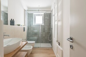 A modern bathroom with a glass-enclosed shower, a white sink, and a toilet. - Palazzo Ferrara Apartments with Balcony by Wonderful Italy (Palermo)
