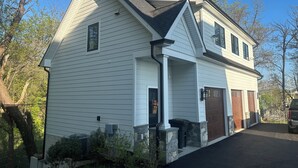 A two-story house with a gabled roof, a front porch, and a garage. - Waterfront Studio minutes from Downtown Annapolis and Naval Academy (Edgewater)