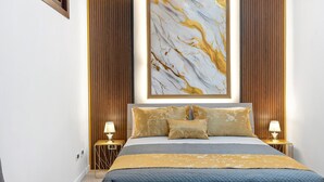 A bedroom with a bed, two bedside tables, a wall-mounted artwork, and a wooden panel wall. - Hilten Luxury Sunset Holiday Home with Mountain View, Private Garden and Wi-Fi (Isola delle Femmine)
