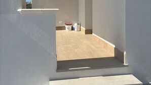 A staircase leading to a room with a view of a cityscape.
