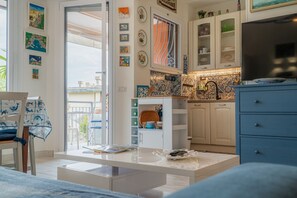 Une cuisine moderne avec des armoires blanches, un plan de travail bleu et un pare-feu en carreaux.