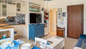 A compact living space with a kitchen, dining area, and a bedroom. - CASA CONCETTA - View with a balcony and a large window (Rapallo)