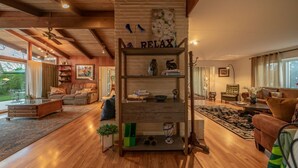 A spacious living room with a wooden bookshelf, a sofa, and a coffee table.