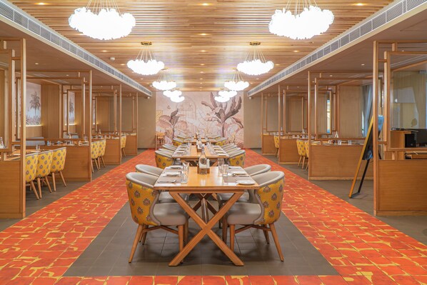 A conference room with a long table, chairs, and a patterned carpet.