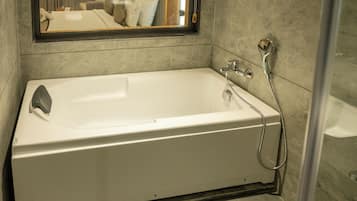 premium king with bathtub | Bathroom | Separate bathtub and shower, free toiletries, hair dryer, slippers