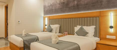 A hotel room with two beds, wooden headboards, a large abstract mural, and a modern design.