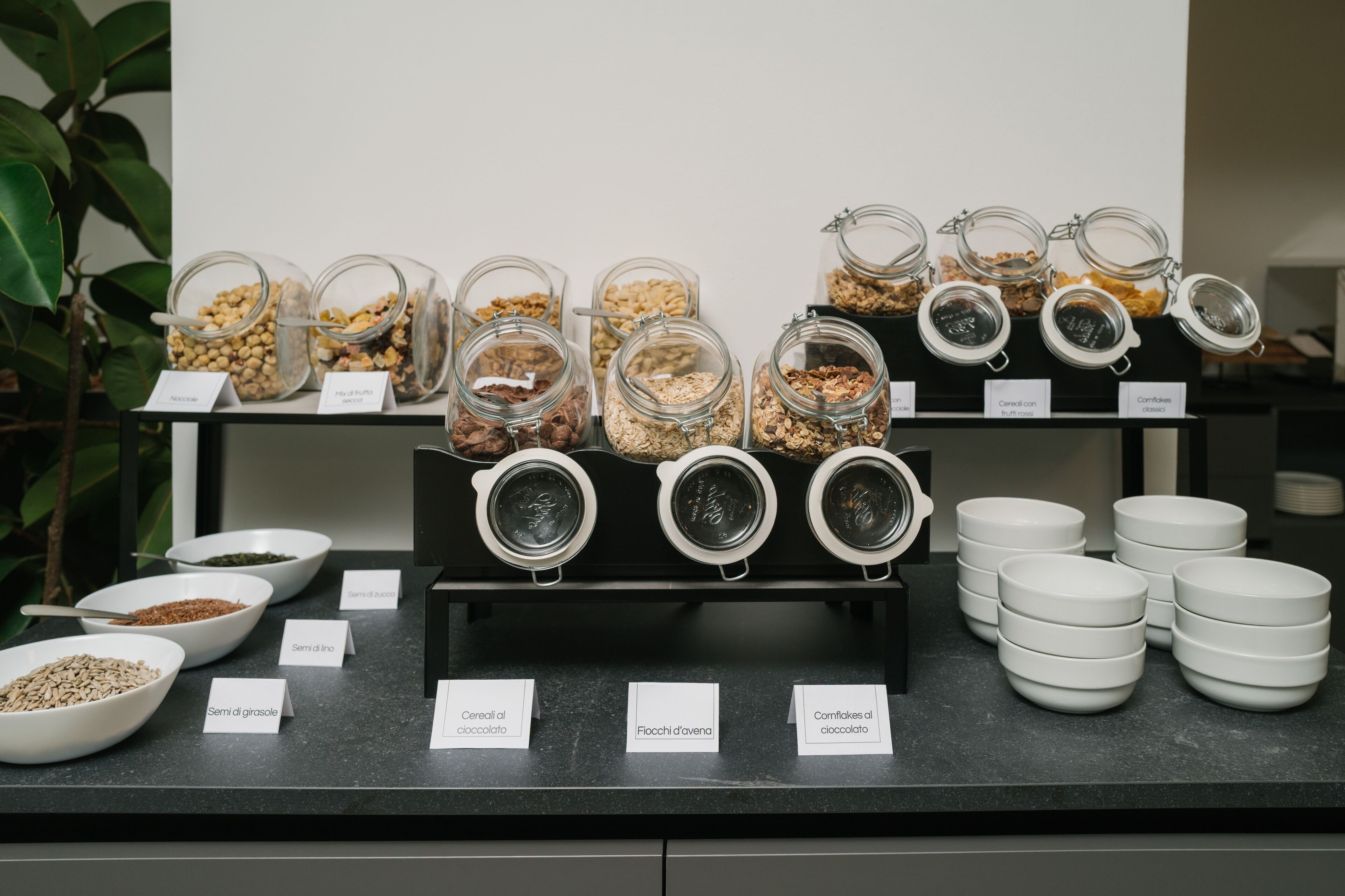 A food display with labeled containers of various grains and cereals.