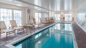 An indoor swimming pool with lounge chairs, large windows, and a sign indicating a fire alarm system. - Charming retreat on 14th Street overlooking the canal White Marlin Open takes place, close to the beach and boardwalk (Ocean City)