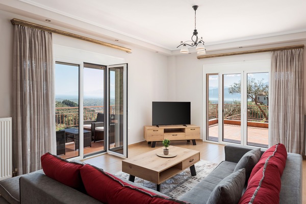 Deluxe Apartment, Balcony, Sea View | Living area | 55-inch flat-screen TV with cable channels