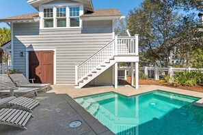A residential property with a swimming pool, a wooden deck, and a staircase leading to a covered area. - WaterSound Retreat | Private Pool | Near 30A Beach (Watersound)