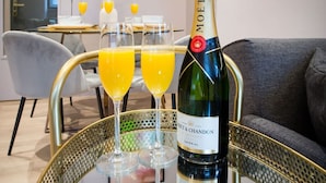 A bottle of Moët & Chandon champagne on a glass table with two glasses of orange juice. - Chic Manchester Chinatown Stay Shops Nightlife (Manchester)