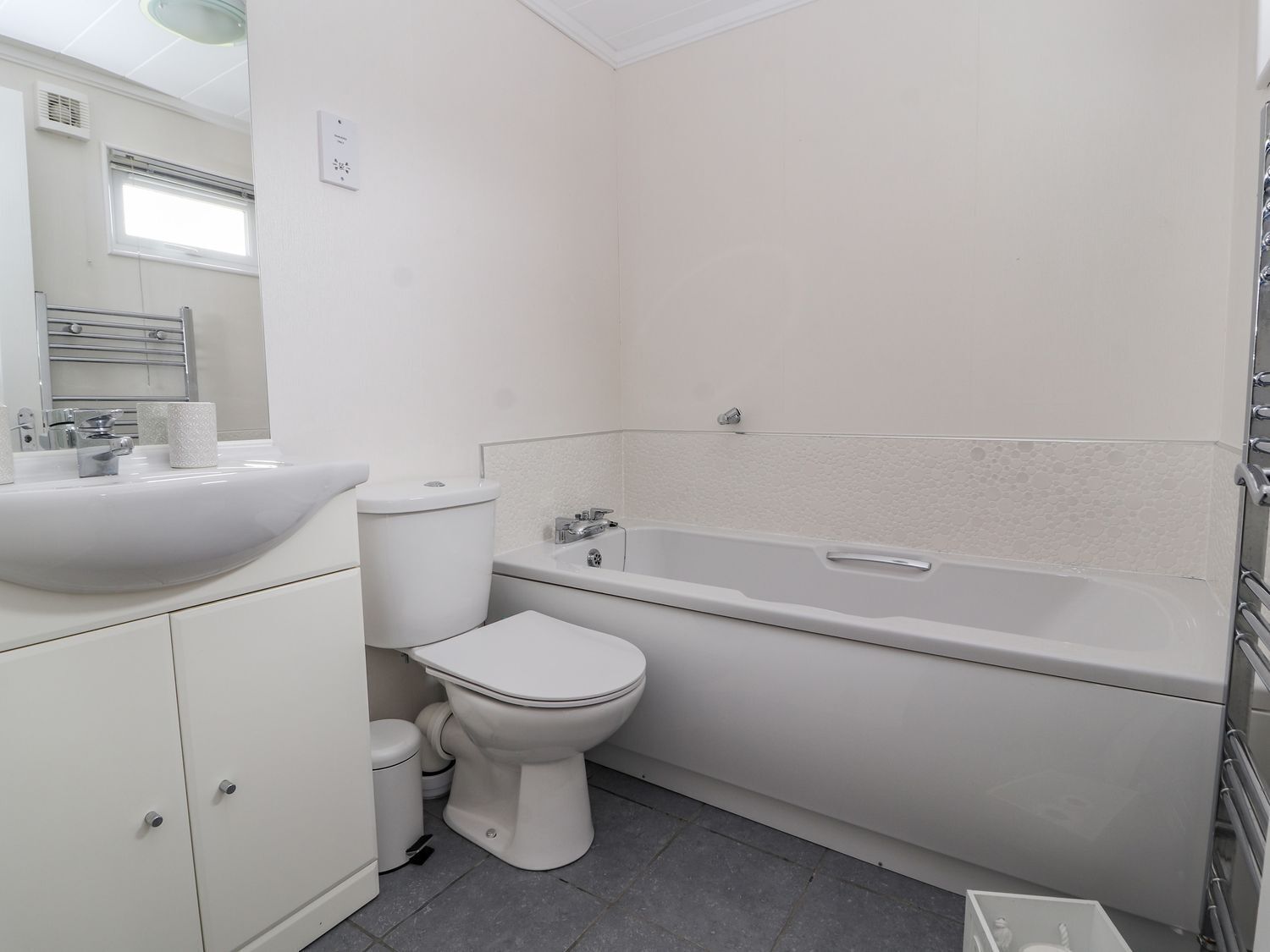 Un baño con lavamanos, inodoro y bañera.