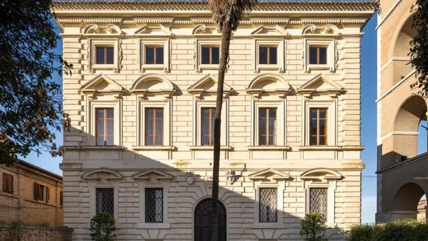 A classical building with a symmetrical facade, arched windows, and a central entrance. - PALAZZO FIORENZI - DIMORA STORICA (Osimo)