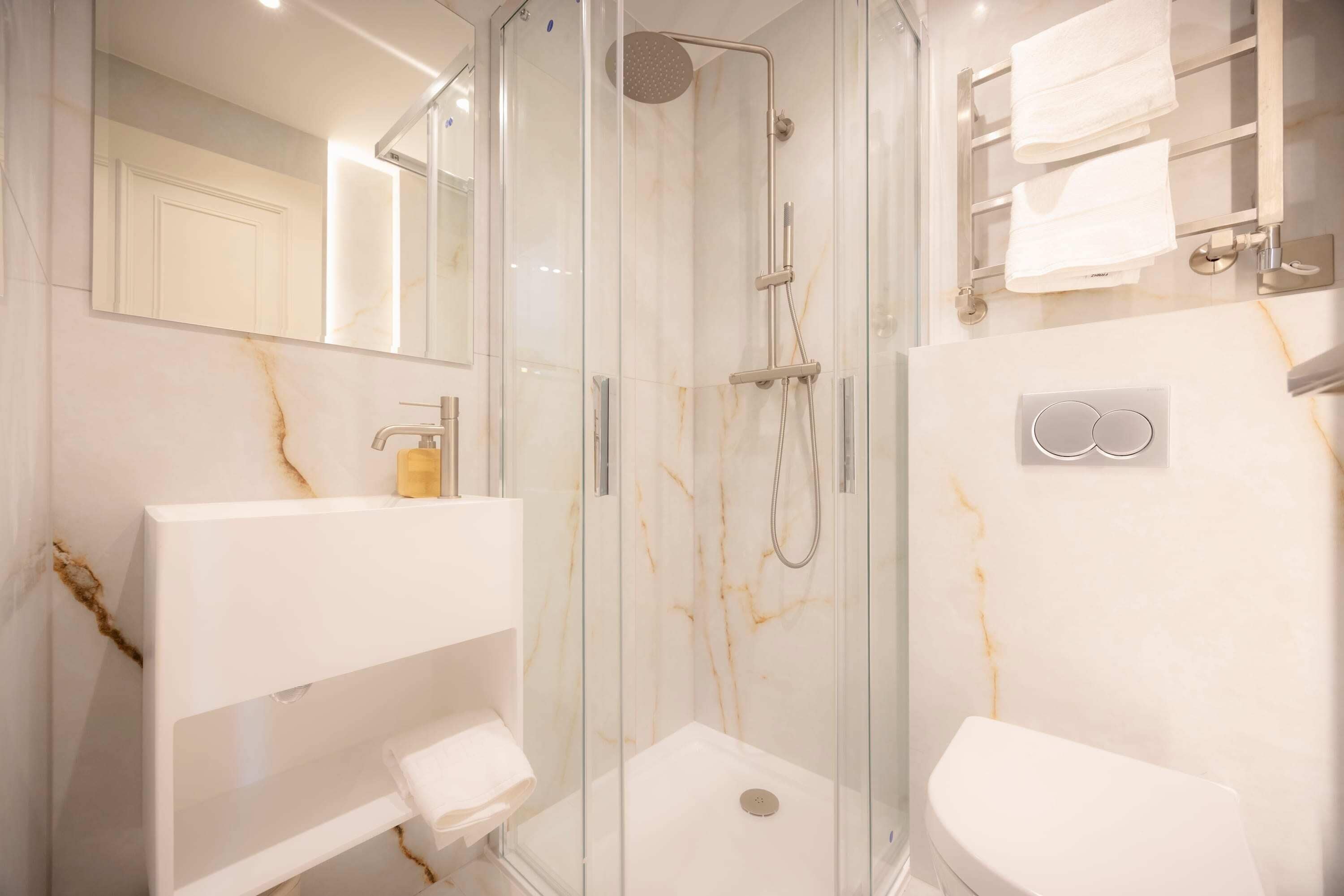 Shower, hair dryer, towels, shampoo