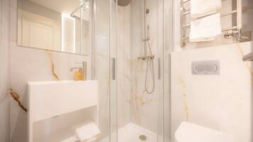 Shower, hair dryer, towels, shampoo