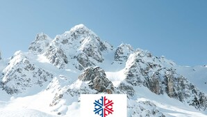 A snow-covered mountain range with a logo in the foreground. - Cozy 2BR Apartment in Courchevel 1850 – Center, Close to Slopes, WiFi, Hammam, Ski Locker (Courchevel)
